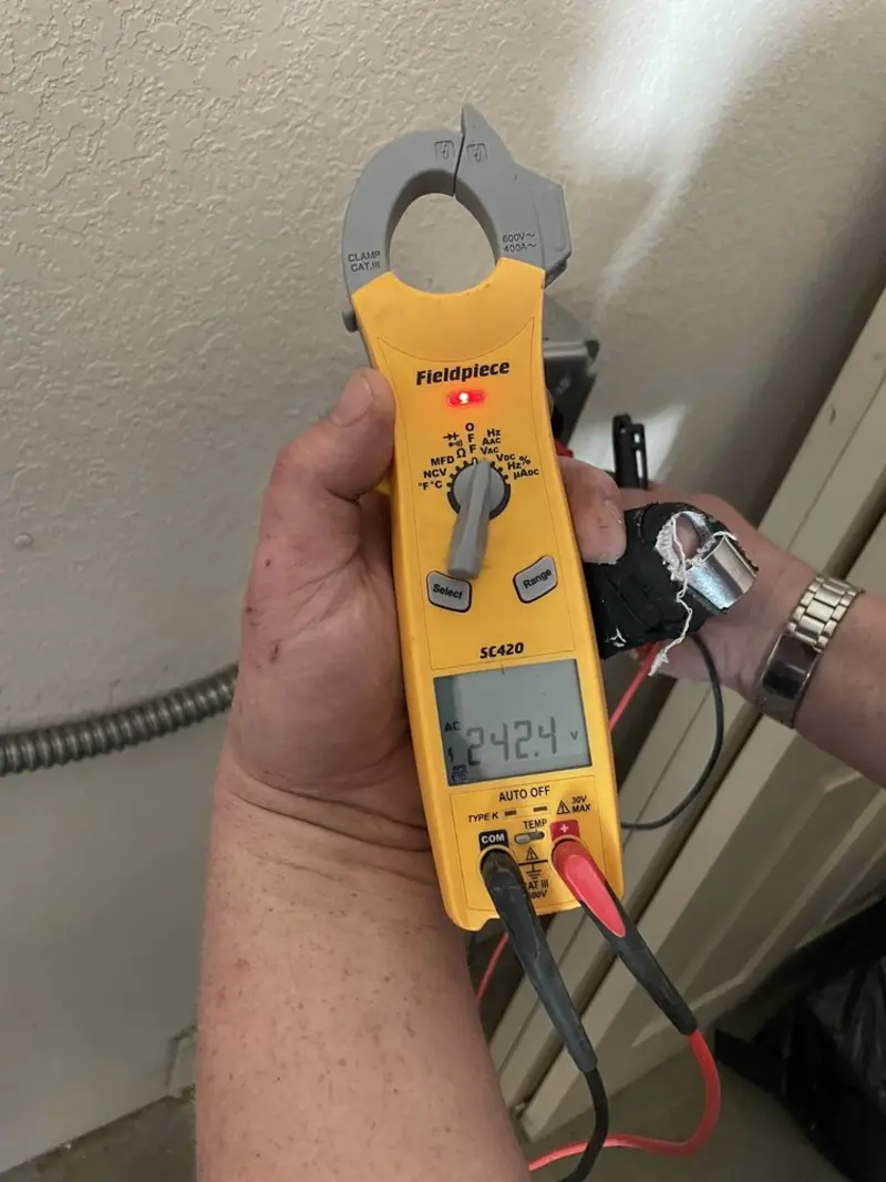 Voltage testing with clamp meter during Electrical Installation Services in Fort Defiance